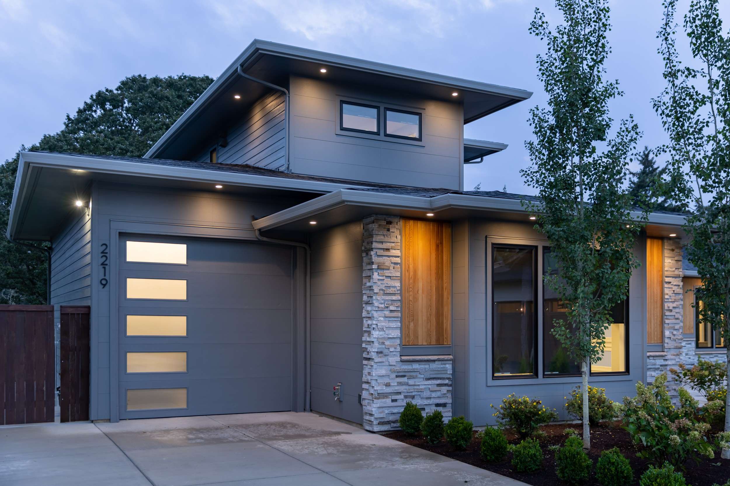 Stratoside displays an example of a modern home with JamesHardie Panels and Stone Veneer.
